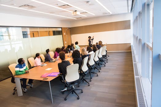 A diverse group actively collaborating in a bright, modern conference room setting.